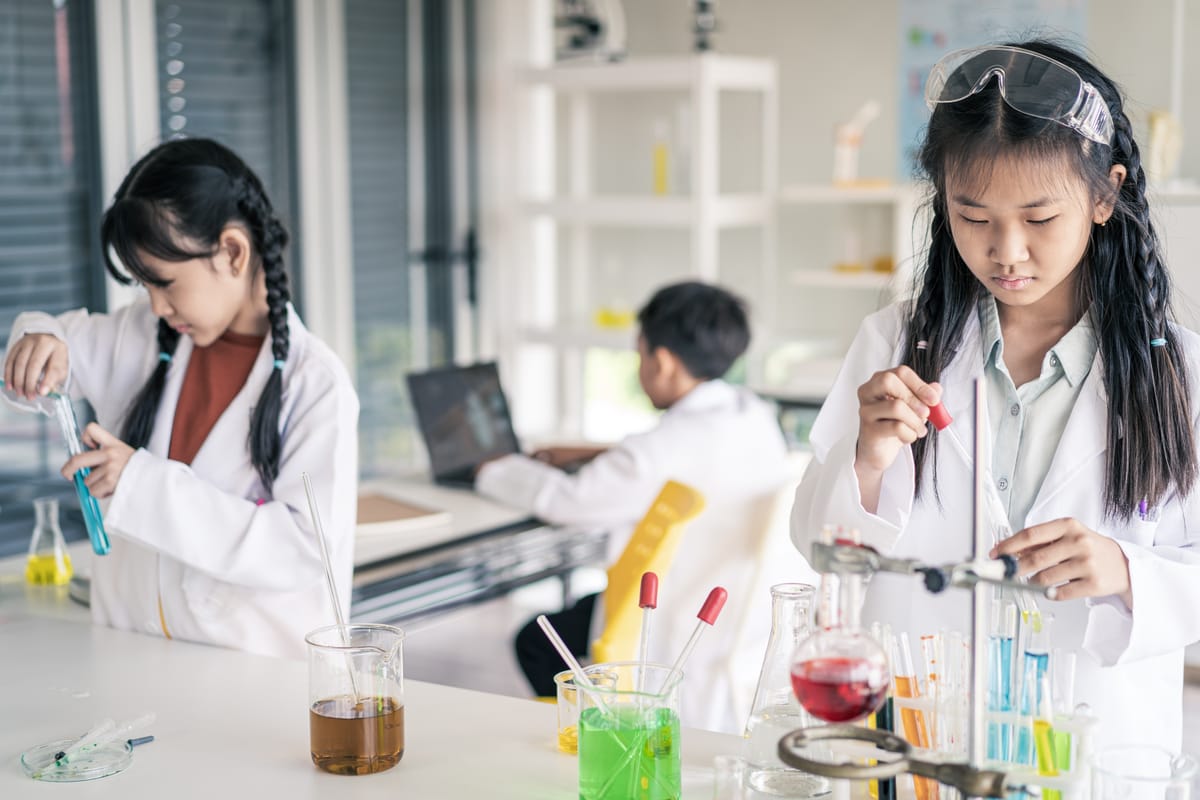 Young Students and friends learning scientist in classroom lab with fun and happiness