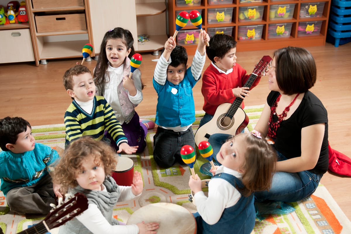A group of preschool children in a music class.
