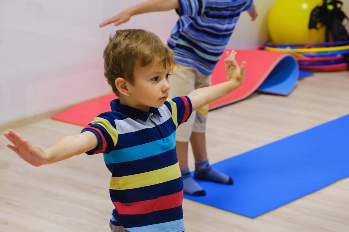 Happy sportsman children exercise in fitness gym.